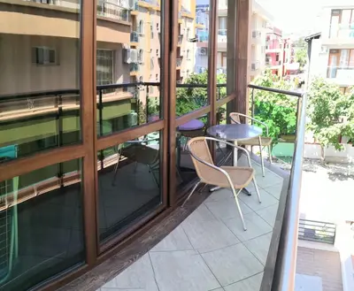 a balcony with chairs and a table on a building at euroHOTEL Primorsko in Primorsko