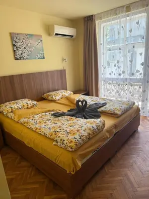 a bedroom with two beds and a window at Rooms in New Town Nessebar by Flat Mаnаger in Nesebar
