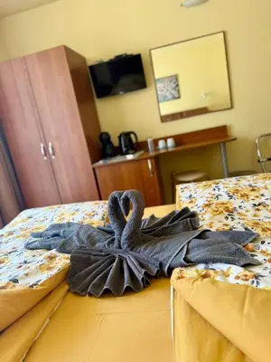 a towel on a bed in a hotel room at Rooms in New Town Nessebar by Flat Mаnаger in Nesebar