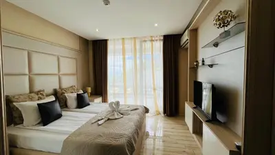 a hotel room with a bed with a bow on it at PARADISO 'В' 102 PRIVATE SEA VIEW Apartment in Nesebar