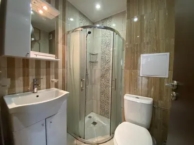 a bathroom with a shower and a toilet and a sink at PARADISO 'В' 102 PRIVATE SEA VIEW Apartment in Nesebar