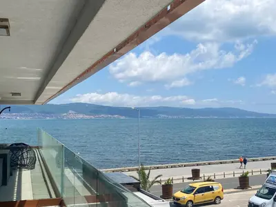 a yellow car is parked on a balcony overlooking the water at PARADISO 'В' 102 PRIVATE SEA VIEW Apartment in Nesebar