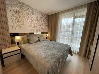 a bedroom with a bed and a large window at Sorrento Sole Mare - Apartments by the beach in Sveti Vlas
