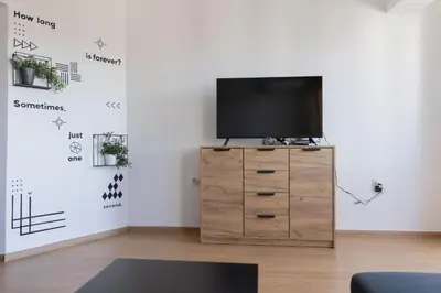 a living room with a tv on a dresser at Lovely 1BD Flat near the Sea Garden by Flat Mаnаger in Burgas City