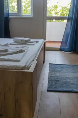 a room with a table with utensils and a blue rug at Lovely 1BD Flat near the Sea Garden by Flat Mаnаger in Burgas City