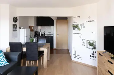 a living room with a dining table and a kitchen at Lovely 1BD Flat near the Sea Garden by Flat Mаnаger in Burgas City