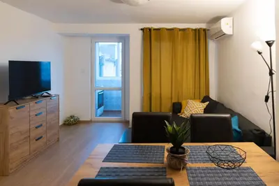 a living room with a couch and a table at Lovely 1BD Flat near the Sea Garden by Flat Mаnаger in Burgas City