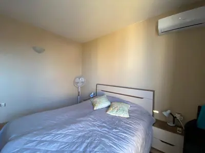 a bedroom with a blue bed with two pillows at AVALON D608 Apartment BIG BAOLCONY Sunny Beach in Sunny Beach