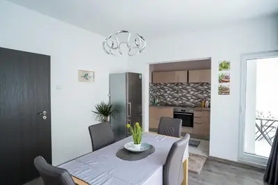 a kitchen and dining room with a table and chairs at Black Sea Top Centre Apartments by Flat manаger in Varna City