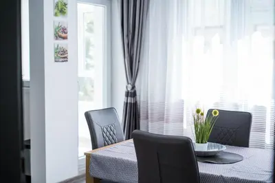 a dining room with a table and chairs and a window at Black Sea Top Centre Apartments by Flat manаger in Varna City