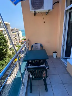 a table and a chair on a balcony at Dadi Oazis Ravda in Ravda