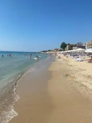 a beach with a lot of people in the water at Dadi Oazis Ravda in Ravda
