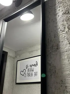 a mirror on a wall with a sign on it at A&K Guest Studio in Varna City