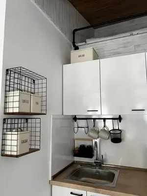 a kitchen with a sink and white cabinets at A&K Guest Studio in Varna City