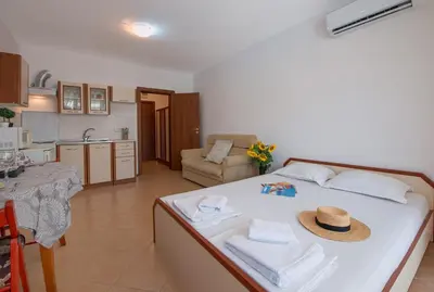 a bedroom with a bed with a hat on it at Chateau Del Mar Holiday Apartments in Sunny Beach