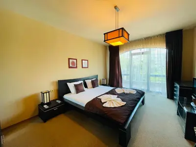 a bedroom with a bed and a large window at Luxury apartment whit sea view at Sunny Beach in Sunny Beach