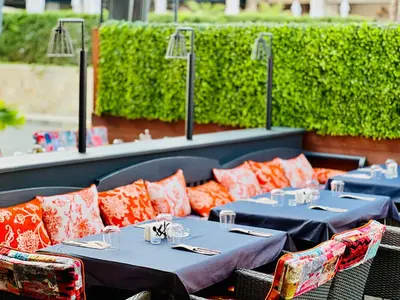 a row of tables and chairs on a patio at Galeon Residence & SPA in Sunny Beach