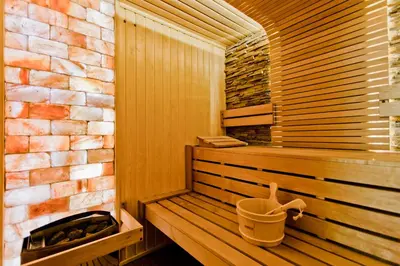 a sauna with a bucket on a wooden bench at Galeon Residence & SPA in Sunny Beach