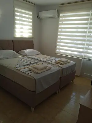 a bedroom with a bed with towels on it at Guest House DARIS-APHRODEYA Къща за Гости ДАРИС-АФРОДЕЯ in Sozopol
