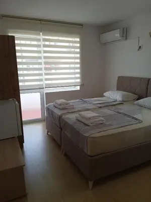 a bedroom with a bed and a large window at Guest House DARIS-APHRODEYA Къща за Гости ДАРИС-АФРОДЕЯ in Sozopol