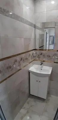 a white bathroom with a sink and a mirror at Sea & chill suite in Burgas City