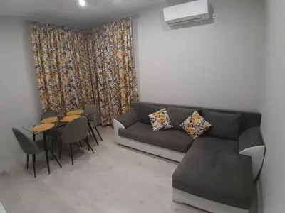 a living room with a couch and a table and chairs at Sea & chill suite in Burgas City