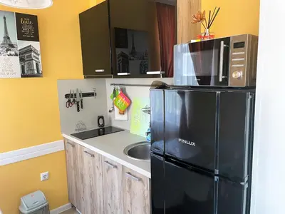 a kitchen with a black refrigerator and a sink at Bright 1BD Apartment with Nice Terrace by Flat Mаnаger in Burgas City