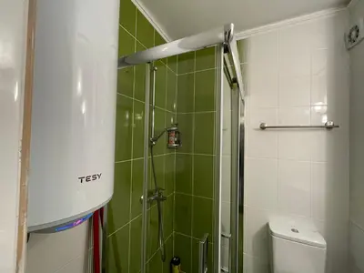 a bathroom with a shower with green tile at Bright 1BD Apartment with Nice Terrace by Flat Mаnаger in Burgas City