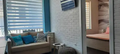 a living room with a couch and a bed at Нава 8 in Burgas City