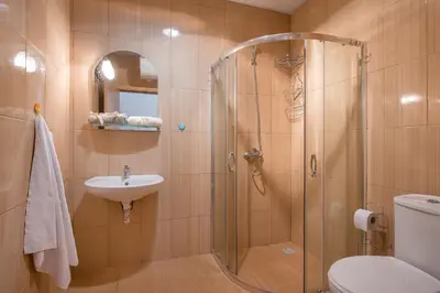 a bathroom with a shower and a toilet and a sink at Sunny View Central Holiday Apartments in Sunny Beach