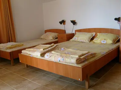 two twin beds in a room with at Сотирови, самостоятелни стаи in Chernomorets