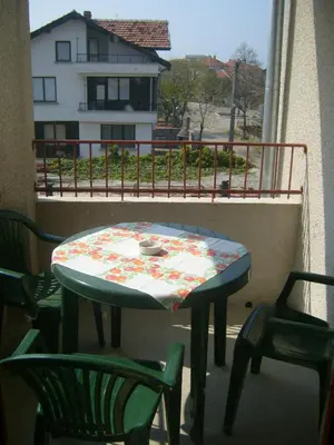 a table and chairs sitting on a balcony with a table at Сотирови, самостоятелни стаи in Chernomorets