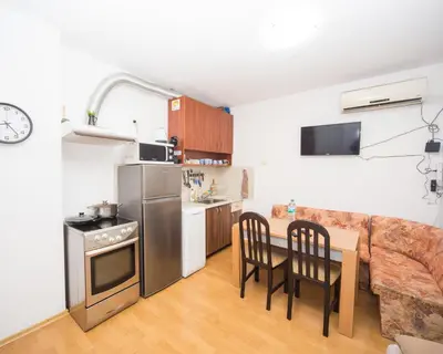 a small kitchen with a table and a couch at SUPER CENTER - Small Flat on 
