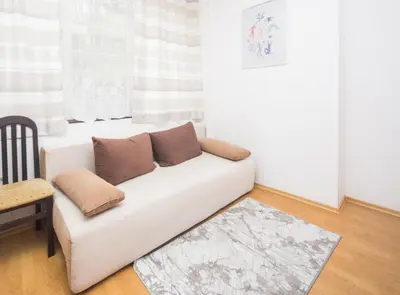 a white couch in a living room with a window at SUPER CENTER - Small Flat on 