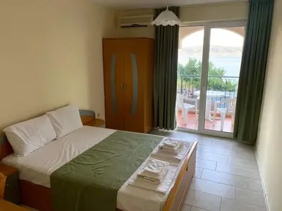 a bedroom with a bed and a view of a patio at Amrita apartments Nessebar in Nesebar