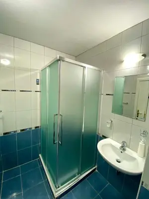 a bathroom with a shower and a sink at Amrita apartments Nessebar in Nesebar