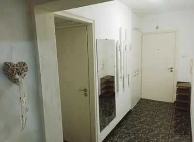 an empty hallway with a door and a mirror at Апартамент Арена Бургас in Burgas City