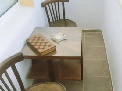 a table with two chairs and a box on it at Апартамент Арена Бургас in Burgas City