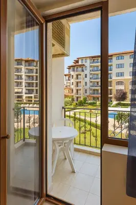 a balcony with a table and a view of a building at Apolon 8 Relax Studio with Pools in Sunny Beach
