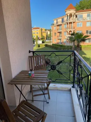 a balcony with a wooden bench and a railing at Hacienda Beach complex- Nicoleta apartment in Sozopol