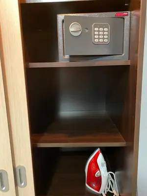 a microwave oven in a cabinet with a pair of shoes at Hacienda Beach complex- Nicoleta apartment in Sozopol