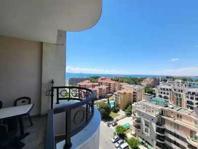 a balcony with a view of a city at Апартамент Сънсет Ризорт in Pomorie