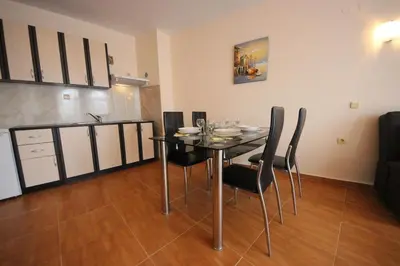 a dining room with a table and chairs in a room at Paradise Dreams - Bulharske More - Sveti Vlas in Sveti Vlas