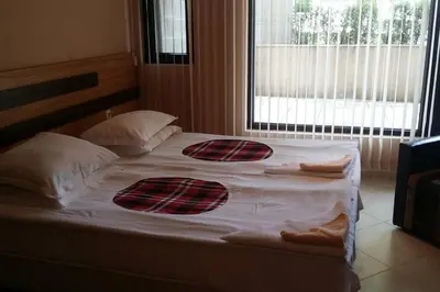 a large bed with two pillows on it in a bedroom at Studio in the center of Sarafovo in Burgas City
