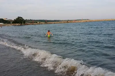 a person in the water with a frisbee at Studio in the center of Sarafovo in Burgas City