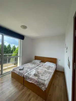 a bedroom with a bed and a large window at Fortuna Cape-Byala SP apartments in Byala