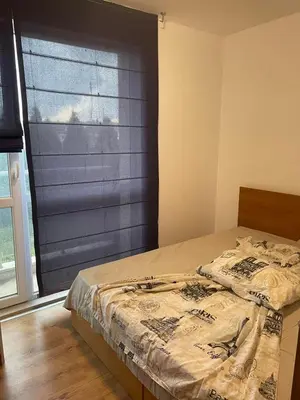 a bedroom with a bed and a window with a shutter at Fortuna Cape-Byala SP apartments in Byala