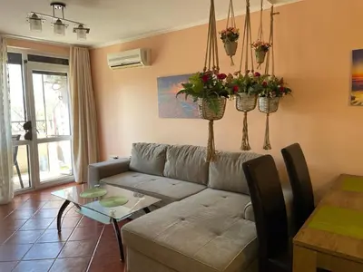 a living room with a couch and a table at VIP Style private apartments in Elenite