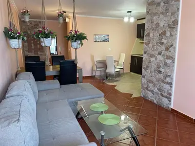a living room with a couch and a table at VIP Style private apartments in Elenite