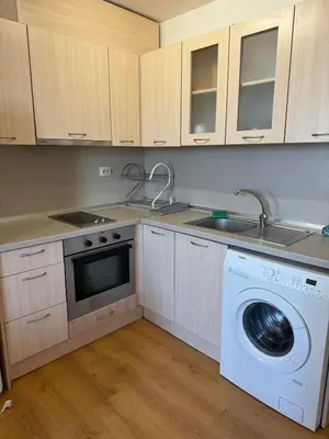 a kitchen with a washing machine and a sink at Bryan